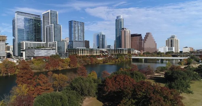 A slow pushing forward aerial establishing shot view (DX) of the Austin, Texas skyline on a sunny late Autumn day.  	