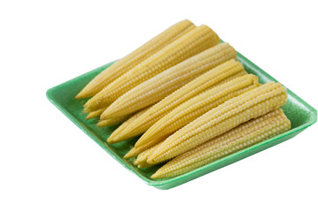 Raw young baby corn   on plate.