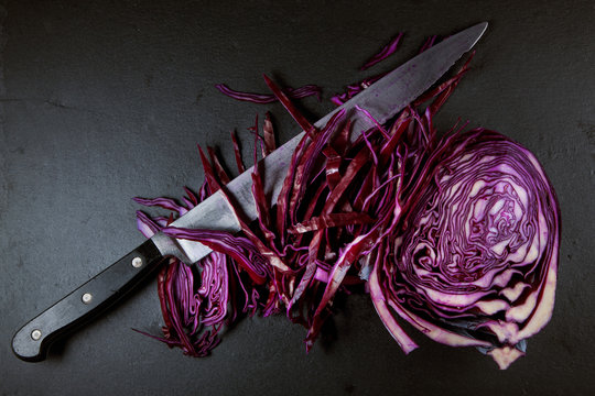 red cabbage cut in half on a slate plate kitchen background