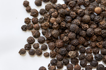 black peppers on white background