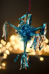 Blue pinata as decoration for Christmas and New Year on bokeh background