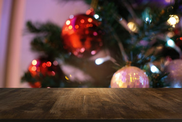 Empty wood table top and blur of glittering shine bulbs night light christmas New Year Celebration. background/selective focus .For montage product display xmas holiday festival backdrop.