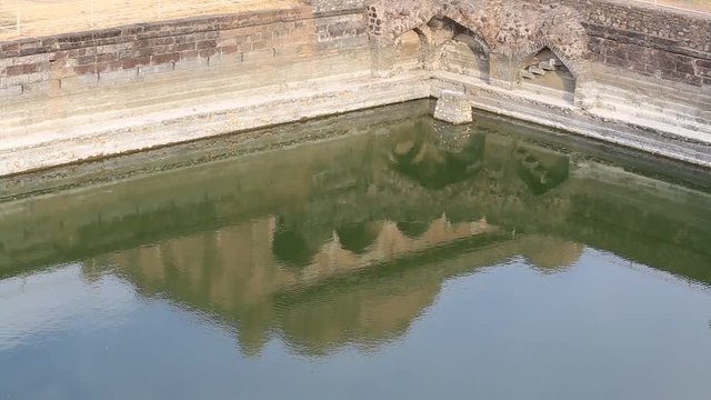 Reflection on the water surface of the architecture of the city Mandu, India
