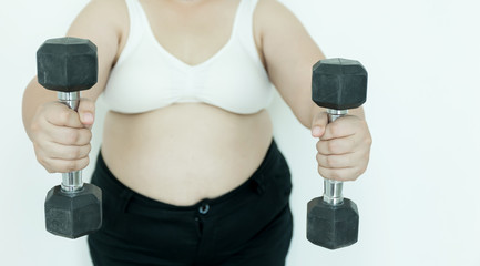 Fat overweight woman holding dumbbells.