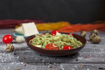 pasta from green spinach with mozzarella, greens and French mustard, quail eggs and cherry tomatoes...