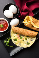 omelette / omelette chapati roll or Indian bread or roti rolled with omlet. Popular, quick and healthy recipe for kid's tiffin or lunch box   © StockImageFactory