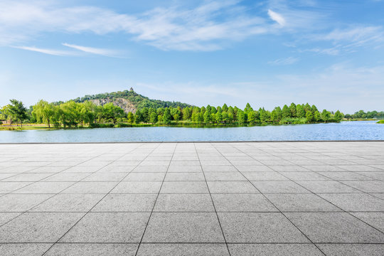 empty square floor and green mountain nature landscape in city park