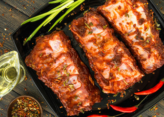Flavored juicy pork ribs with red peppers, green onion and olive