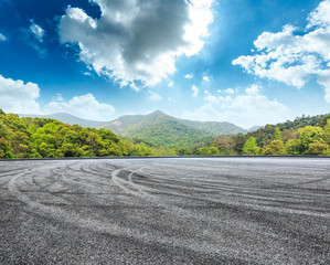 circuit asphalt road and green mountain nature landscape under the blue sky