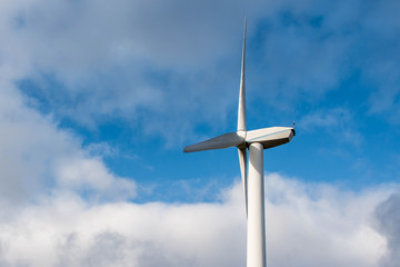Isolated Silhouette of windturbine energy generator on blue cloudy sky at a wind farm in germany