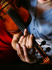 man teaching girl to play violin. classical instrument tutor. sharing experience. help support...