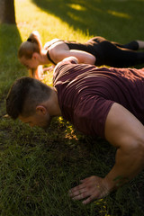 Naklejka na ściany i meble paired workout outdoor push-up sport exercises concept. work of trainer. lifestyle of sportsman.