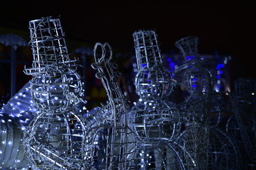 New Year snowmen made of metal rods. The shooting took place at night. - 185639582