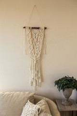 Macrame wall art in beige interior
