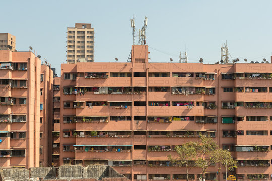 Section from the exterior of an residential building, all balconies full of laundry hanged, Mumbai, India