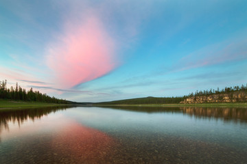 Red clouds over boreal river. The River Amga. Yakutia.