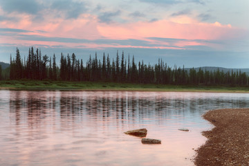 Red clouds over boreal river. The River Amga. Yakutia.