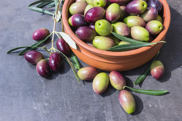 Ripe dark olives in a ceramic bowl. Concept - Mediterranean cuisine, vegetarianism and longevity.