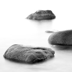 Monochrome black & white shore sea water and stones on the Orlowo beach in Gdynia, Tricity, Poland