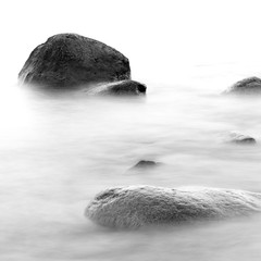 Monochrome black & white shore sea water and stones on the Orlowo beach in Gdynia, Tricity, Poland