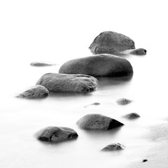 Monochrome black & white shore sea water and stones on the Orlowo beach in Gdynia, Tricity, Poland