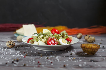 pasta from green spinach with mozzarella, greens and French mustard, quail eggs and cherry tomatoes...