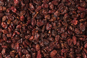 dry red barberry spice as a background, natural seasoning texture