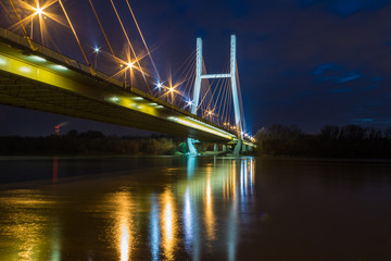 Suspension bridge across the Vistula River in Warsaw by night