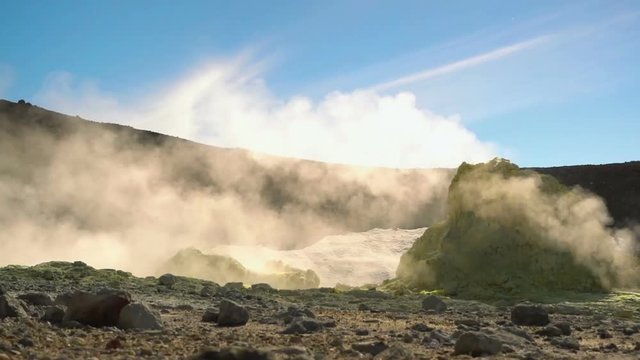 Fumarole field in Ebeko volcano caldera. Emission of hot sulfur gas.