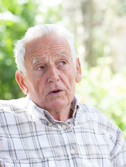 Depressed old man in park