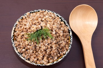 Cooked buckwheat. Healthy lunch. Brown background