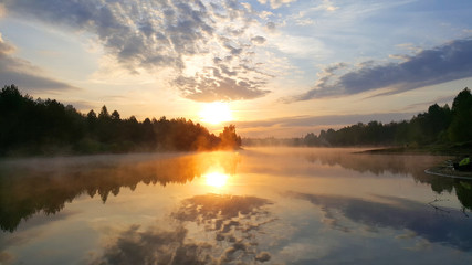 Fototapeta na wymiar Sunrise on the forest lake