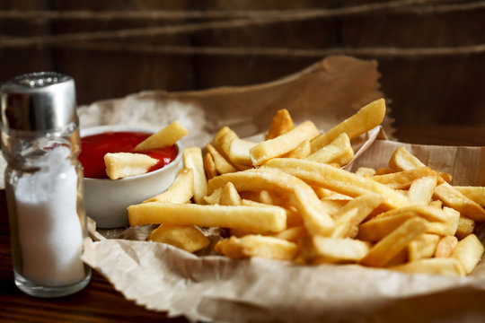 tasty French fries on wooden table