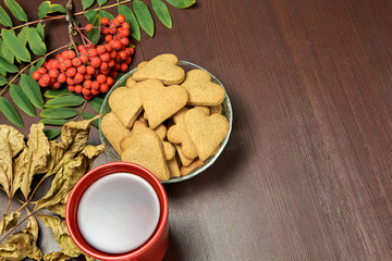 Heart cookie. Yellow leaves. Rowan branch. Black tea. Autumn still life