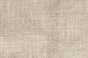 Jute hessian sackcloth woven burlap texture background in sepia cream brown color