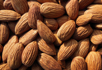 Closeup of Almond nuts heap abstract food product background