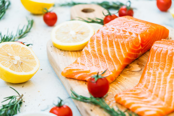Raw and fresh salmon meat fillet on wooden cutting board
