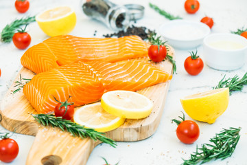 Raw and fresh salmon meat fillet on wooden cutting board