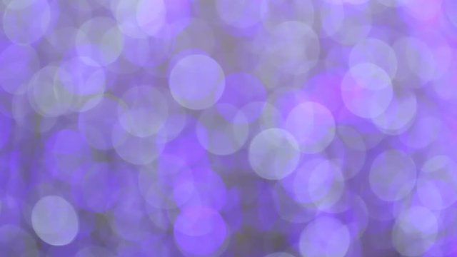 Blurred purple glitter vintage Blinking christmas lights LED bulbs motion, Close up of big bokeh lights loopable background, Defocused or Abstract Neon lights.