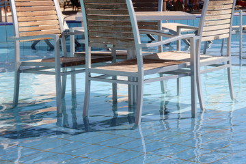 Fototapeta na wymiar Beach cafe / chairs and tables are in the water