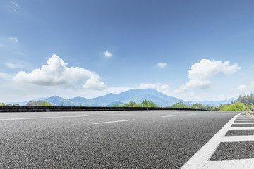 empty asphalt highway and mountain natural scenery under the blue sky