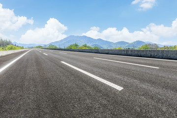empty asphalt highway and mountain natural scenery under the blue sky