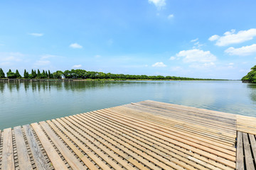 wooden board observation deck and lake landscape in city park