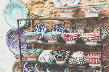 Plates, tajines and pots made of clay on the souk in Marocco.