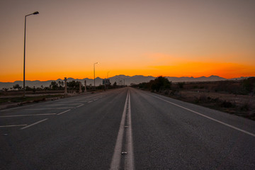 Fototapeta premium On a lonely road in sunset all alone