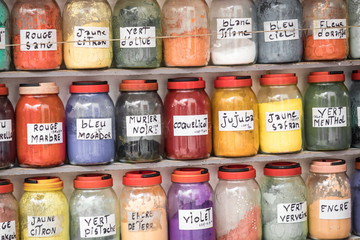 Assortment of glass jars on shelves in herbalist shop on a traditional Moroccan market (souk) in...