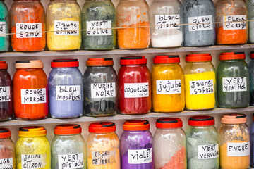Assortment of glass jars on shelves in herbalist shop on a traditional Moroccan market (souk) in Essaouira, Morocco