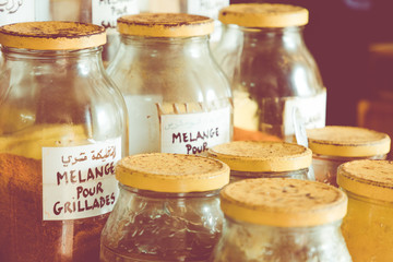 Assortment of glass jars on shelves in herbalist shop on a traditional Moroccan market (souk) in Essaouira, Morocco