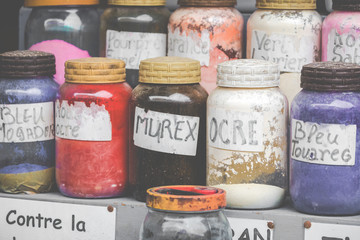 Assortment of glass jars on shelves in herbalist shop on a traditional Moroccan market (souk) in Essaouira, Morocco