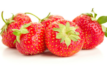 many berries ripe juicy strawberries on a white table